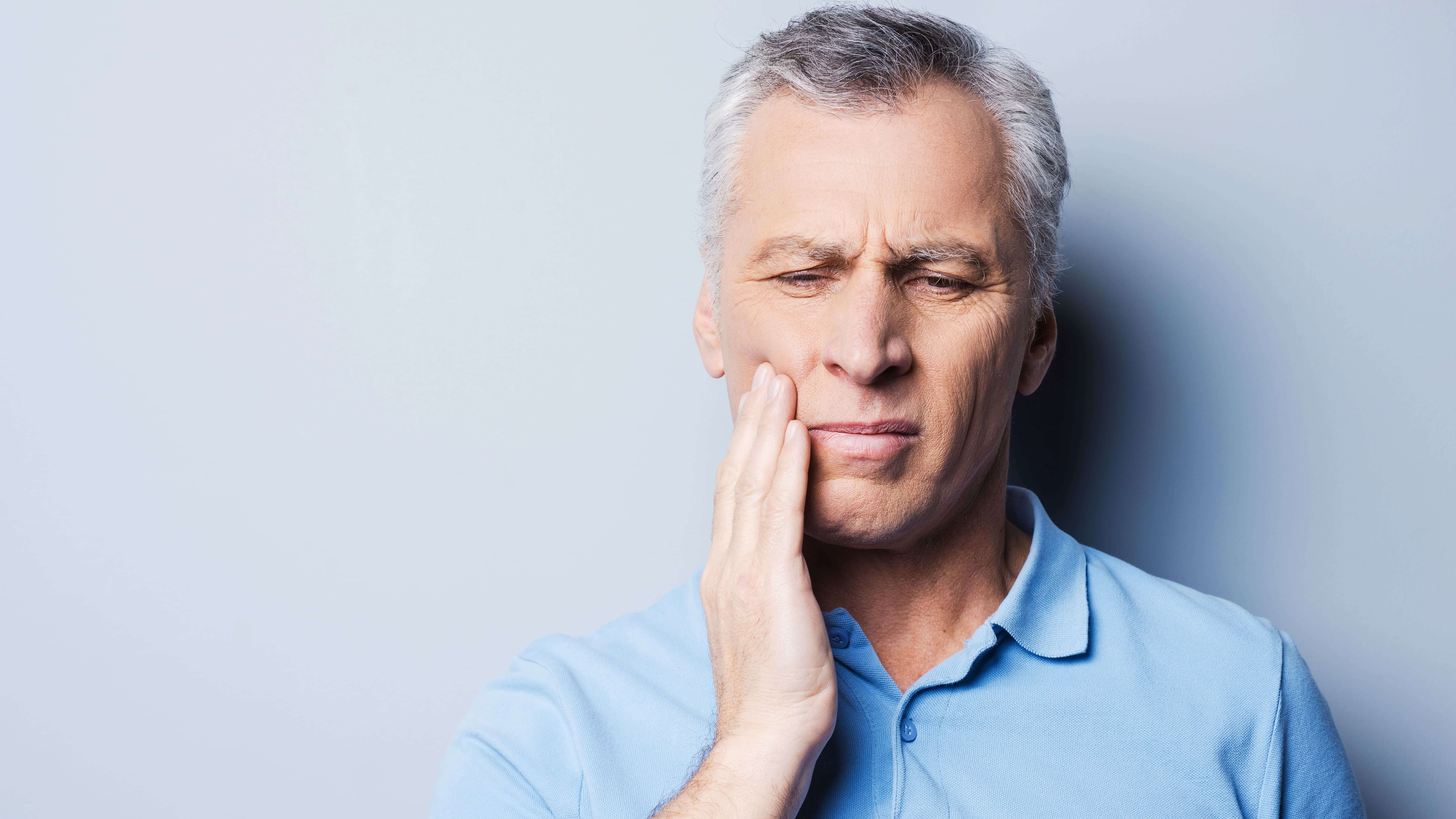 man holding jaw